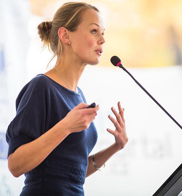 a woman speaking into a microphone